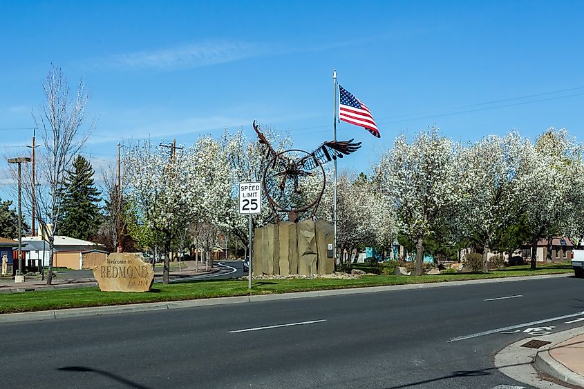 Welcome to Redmond" sign in the urban area of downtown Redmond, Oregon, USA.