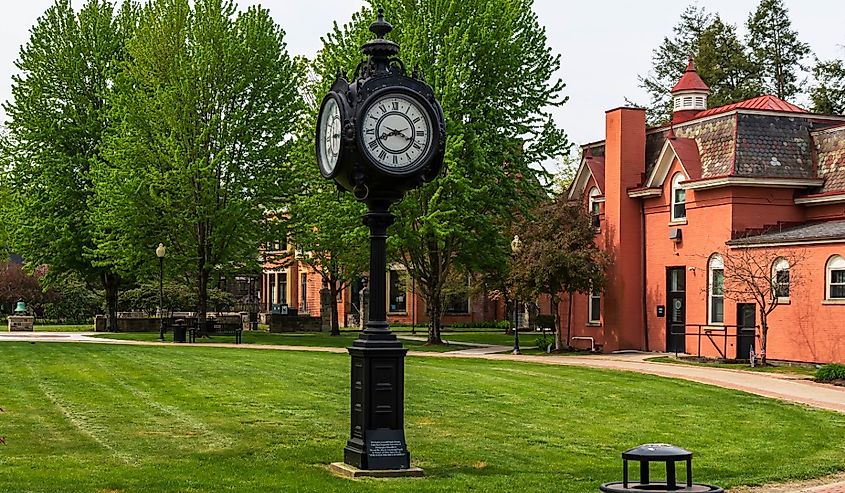 A clock on the campus of Pitt-Titusville University and Bennet Davis Hall.