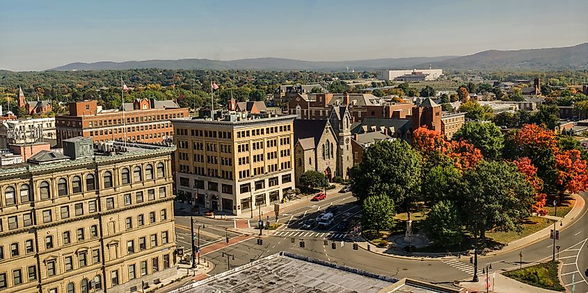 View of downtown Pittsfield, Massachusetts, featuring the Park Square area with its green space, surrounded by historic buildings and local businesses.