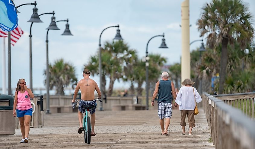 Tourists walking and biking Myrtle Beach Boardwalk