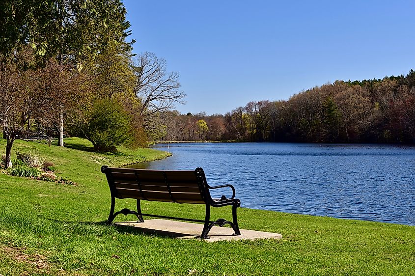 Empty bench overlooking Dean Park Pond in Shrewsbury, Massachusetts