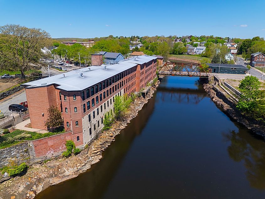 Sayles Street Bridge and Glenark Mills building on Blackstone River aerial view in downtown Woonsocket, Rhode Island RI, USA.