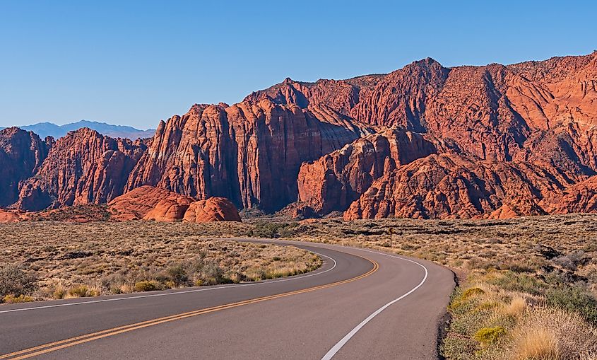 A winding road leads into a red rock canyon in Snow Canyon State Park, Utah