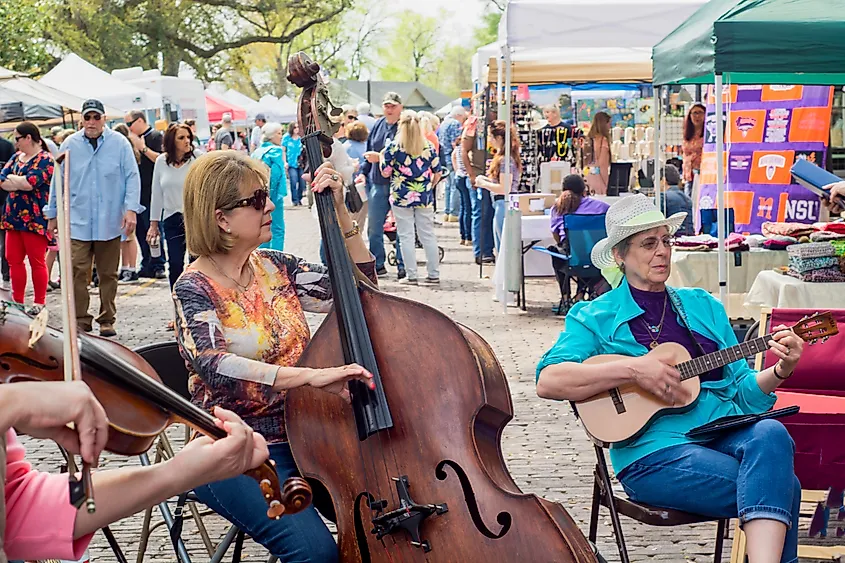 Musicians performing with their instruments at the Bloomin' on the Bricks Spring Festival in Natchitoches, Louisiana.
