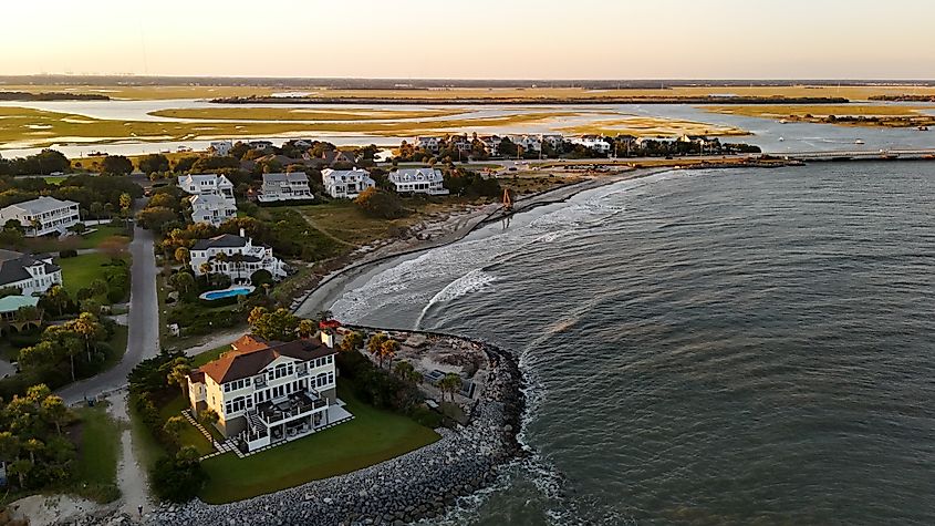 The shoreline of Sullivan’s Island, South Carolina, featuring a pristine sandy beach with gentle waves lapping at the shore.