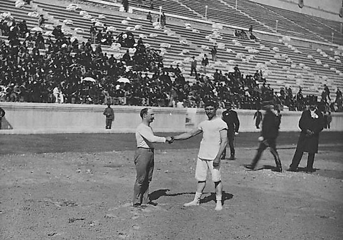 Two wrestlers shaking hands before their event in Athens, 1896.