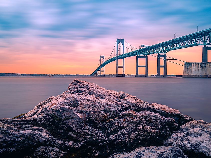 Dramatic sunset landscape over the Claiborne Pell Newport Bridge, a modern tolled suspension bridge across Narragansett Bay, connecting Newport and Jamestown, Rhode Island.