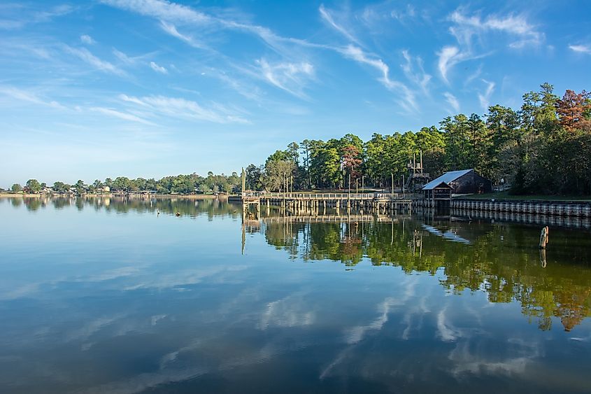 Serene view of Lake Livingston reservoir with nice coulds reflecting in still waters in the East Texas Piney Woods in Polk County, Texas, United States.