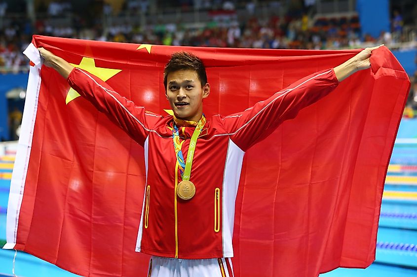 Olympic champion swimmer Yang Sun of China during medal ceremony after Men's 200m freestyle of the Rio 2016 Olympics. Editorial credit: Leonard Zhukovsky / Shutterstock.com