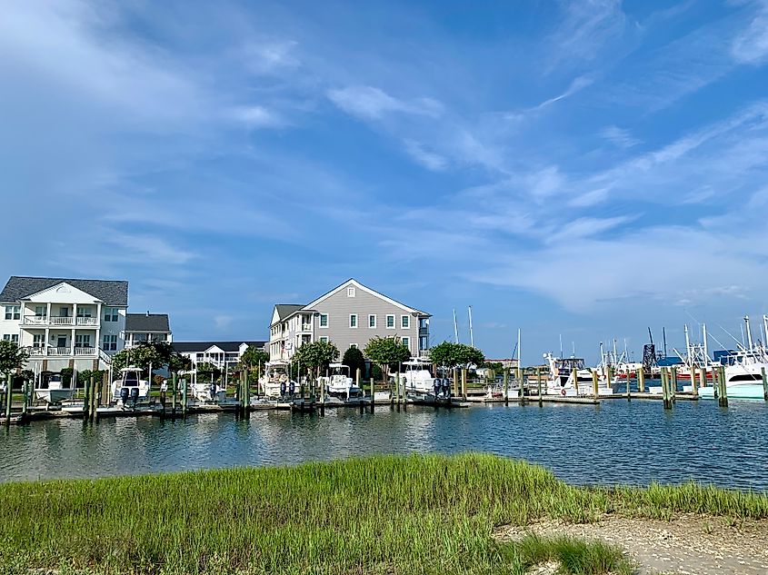 Waterfront homes, sport fishing boats, and shrimp trawlers in Beaufort Harbor, Outer Banks, North Carolina.