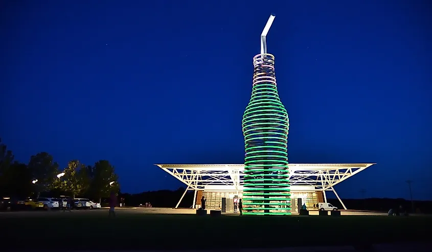 neon, 66-foot-tall soda bottle in front of POPS
