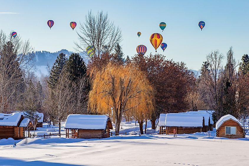 Hot air balloons over snow covered village in Winthrop, Eastern Washington.