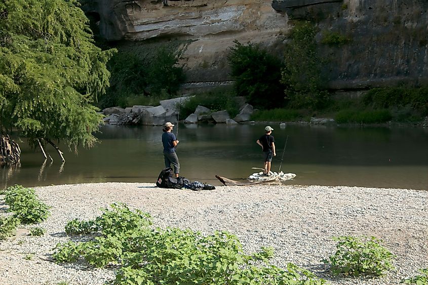 A father and son fishing in the Guadalupe River.