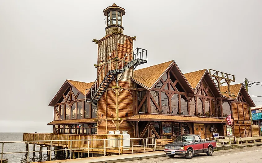 The Sea Breeze Restaurant with a historic lighthouse in downtown Cedar Key, Florida.