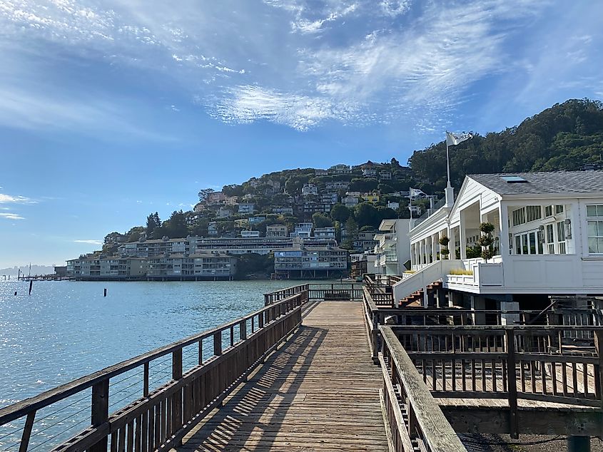 A wooden boardwalk in Sausalito looks ahead to colorful hillside homes. 