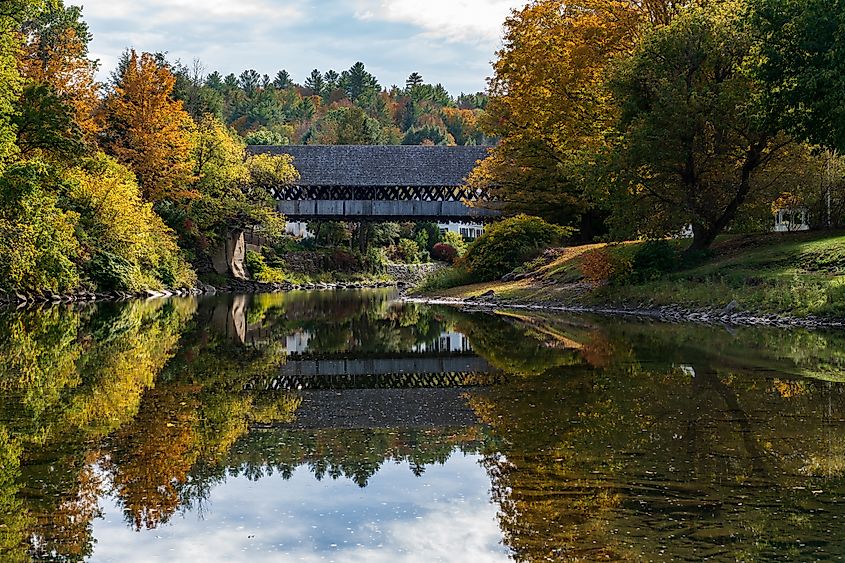 Ottauquechee River flows under the Middle Covered Bridge in Woodstock, Vermont.