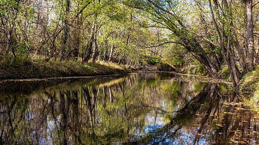  Calumet Creek near Clarksville, Missouri, with surrounding landscape reflected in its waters.