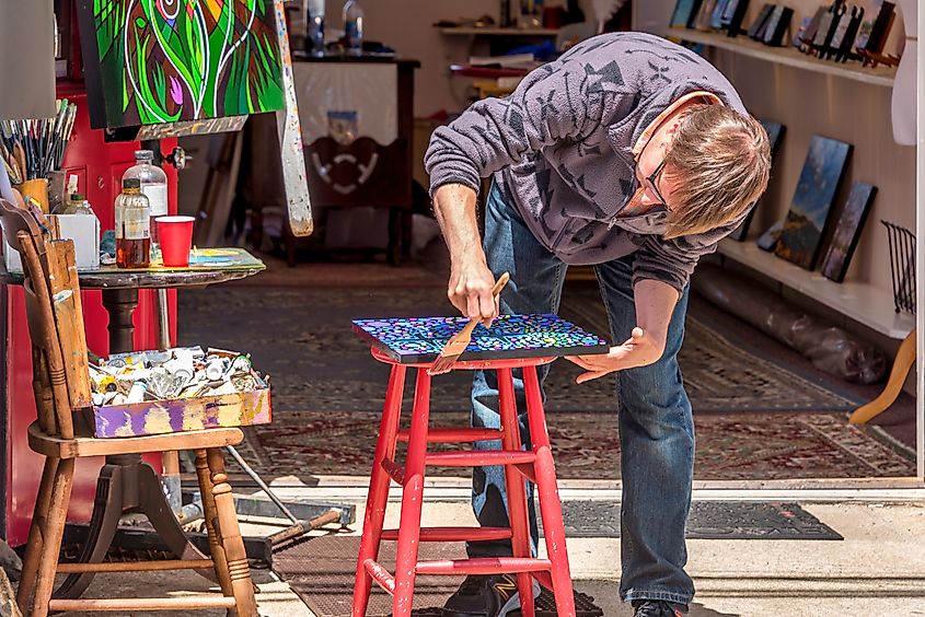  An artist stands in his studio in Rockport.