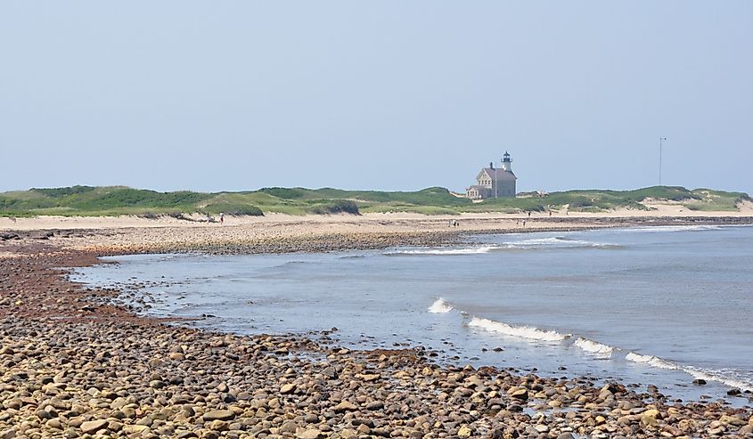 Pebbled beach of Block Island Sound, with a house on Block Island