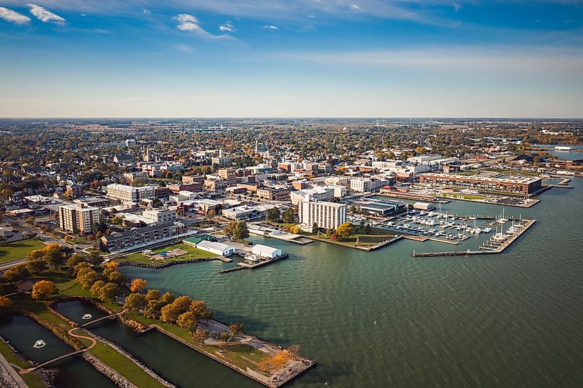  Boats sit idle, docked to piers in a harbor along the coast just outside of downtown Sandusky, Ohio.