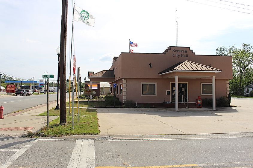 Screven City Hall in Screven, Wayne County, Georgia, a modest brick building with a small lawn and flagpole out front.