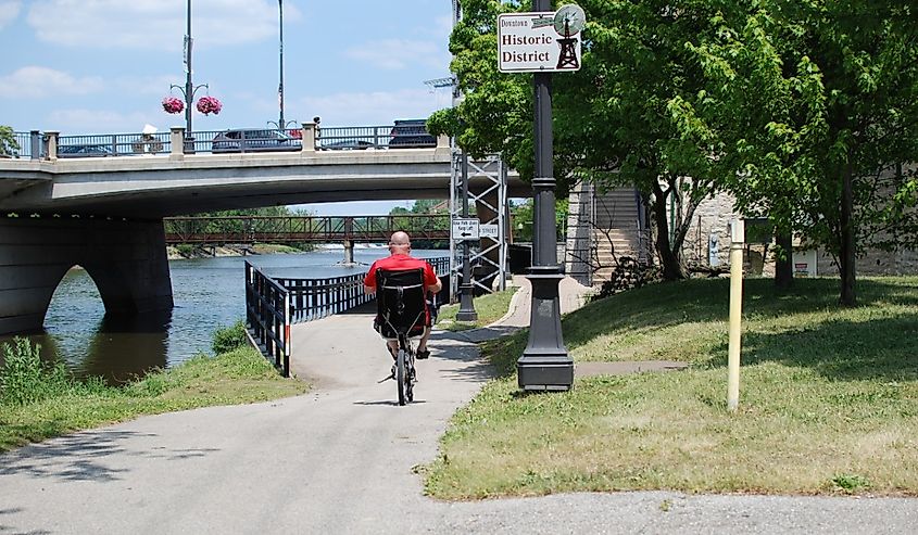 A man enjoys cycling on the trail along the Fox River in Geneva, Illinois.