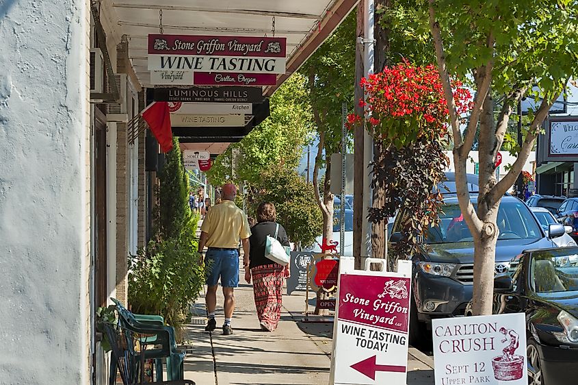 People walk the sidewalk in downtown Carlton, Oregon during the annual wine crush festival. Editorial credit: Dee Browning / Shutterstock.com