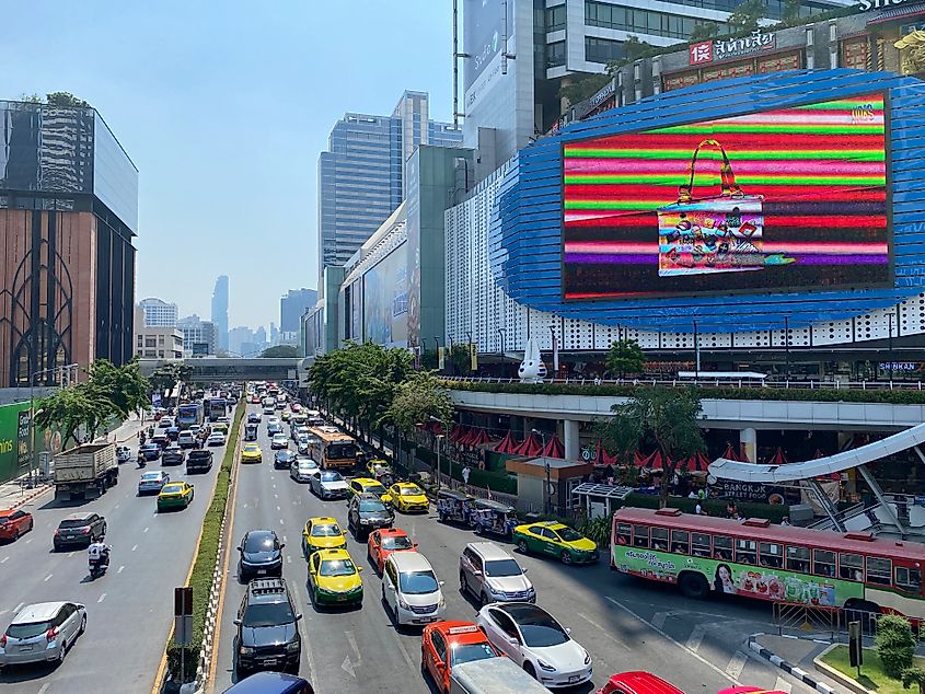 The frenetic street outside of Bangkok's massive MBK mall on a beautiful sunny day. 