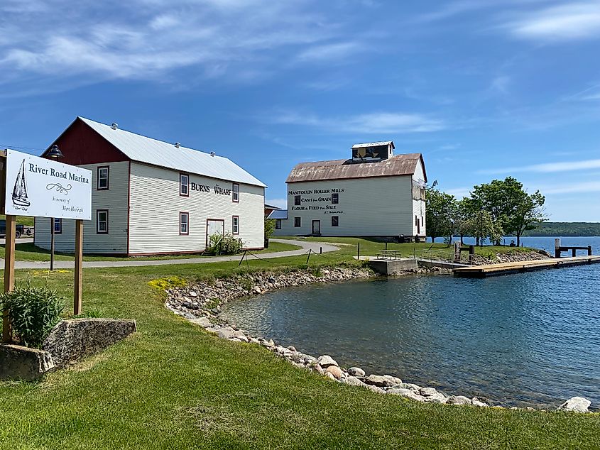 A quaint marina wharf complimented by green grass and blue skies