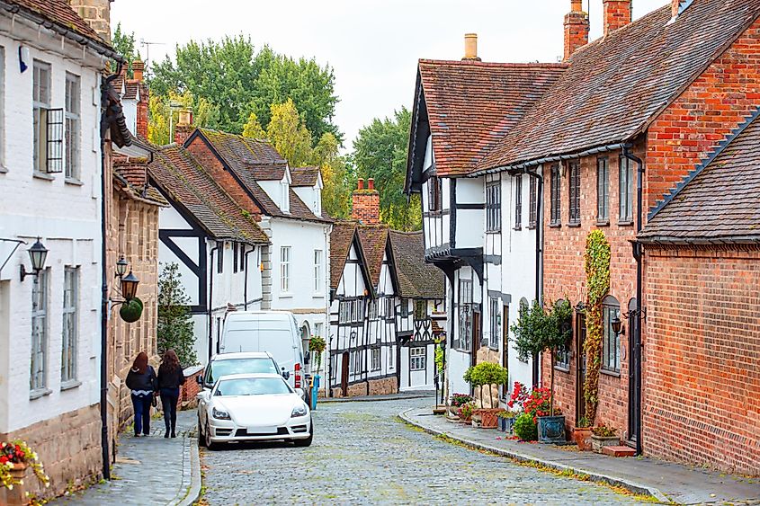 Cobbled street with medieval timbered houses in Mill Street Warwick