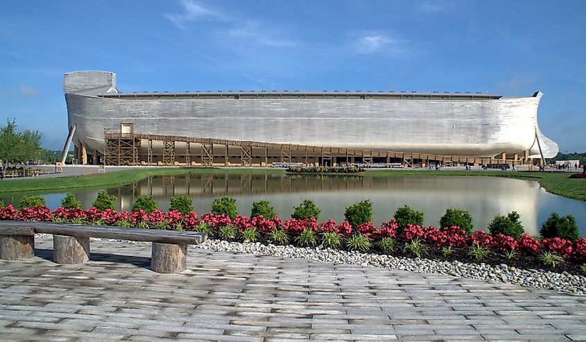 Noah's Ark Replica at Ark Encounter, side view under a clear blue sky with reflection in the water of giant wooden boat ship, Williamstown, KY