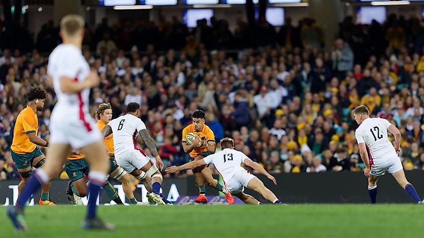 Hunter Paisami of the Wallabies tackled during a match against England at the SCG in Sydney, Australia. Image Credit IOIO IMAGES via Shutterstock.