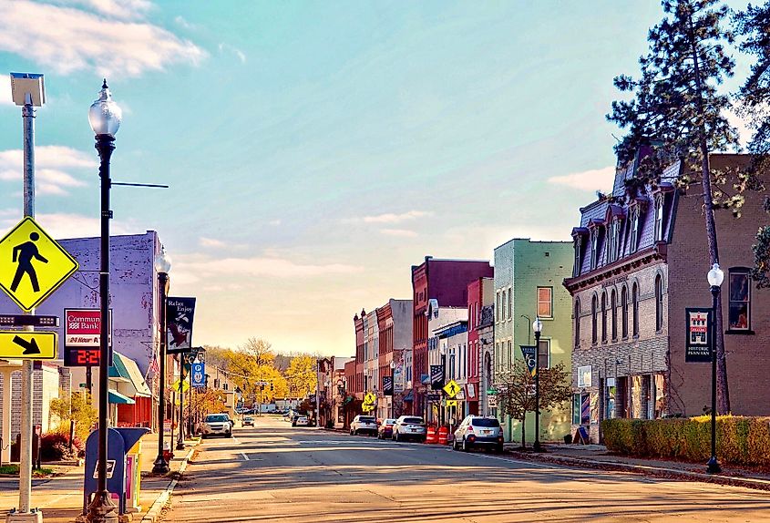 Penn Yan Historic District in Penn Yan, New York, featuring a Victorian commercial building, Struble’s Arcade, on the right. An ATM sign from ‘Community Bank’ is visible on the left, adding to the charm of the small-town streetscape.