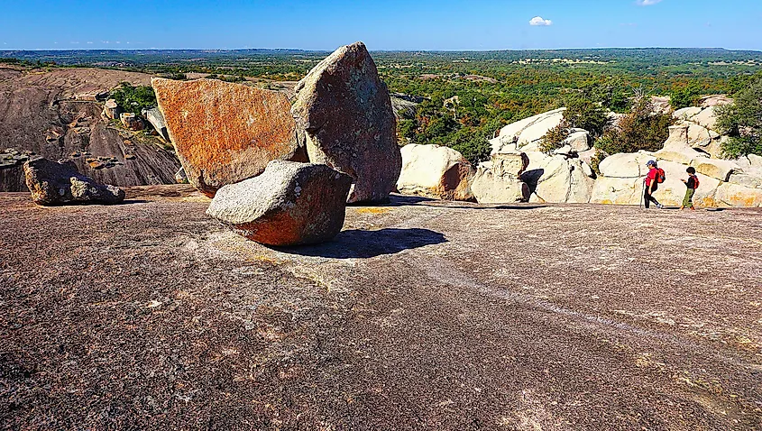 People exploring the Enchanted Rock State Natural Area, Texas.
