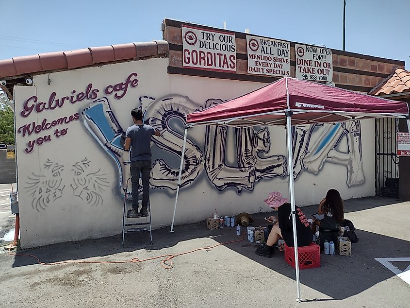 Tino Ortega works on Ysleta Mural June 2022 at Gabriel's Cafe