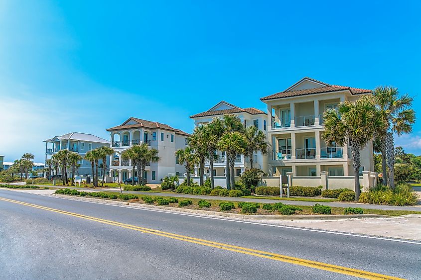 Destin, Florida- Fenced beach houses with concrete sidewalks near the highway.