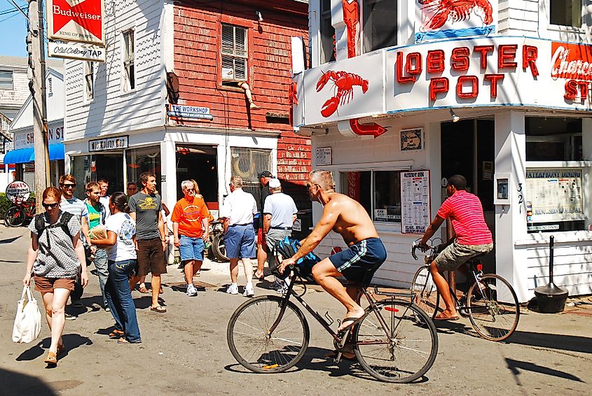 A summer crowd walks and bikes in downtown Provincetown, Massachusetts.