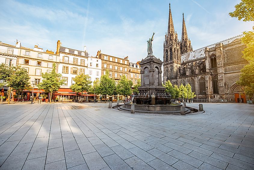 Morning view on the Victory square with monument and cathedral in Clermont-Ferrand city in France.