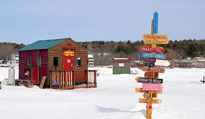 Signs point the way to a multitude of ice fishing shacks on a frozen Lake Winnipesaukee in Meredith, New Hampshire