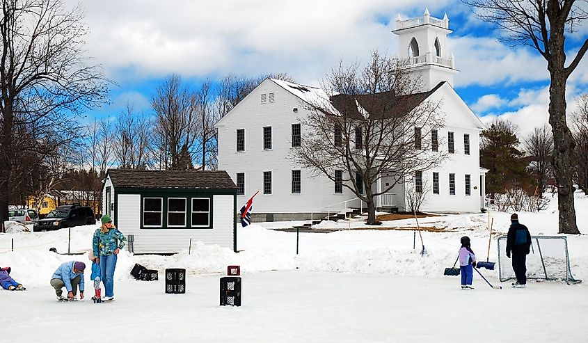 People gather on a frozen pond to ice skate and play hockey in New London, New Hampshire.