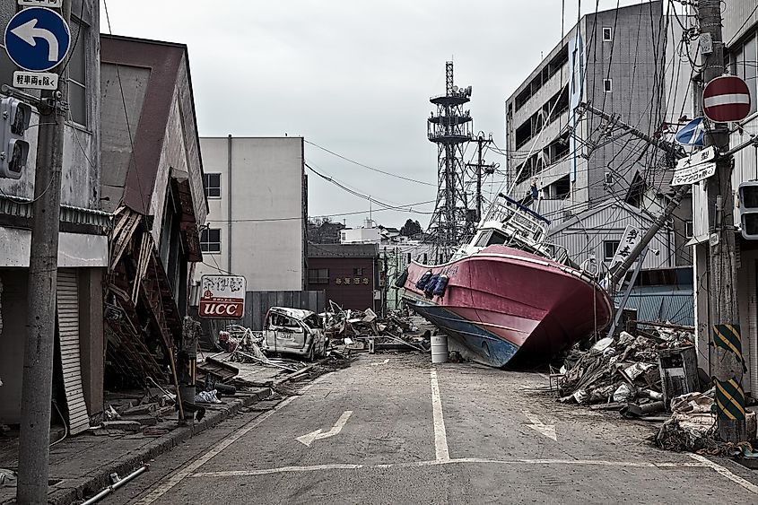 A boat sitting in the middle of town after being thrown onto land by the tsunami.