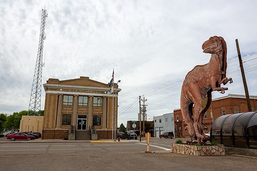 A dinosaur statue next to the City Hall building in Glendive, Montana.