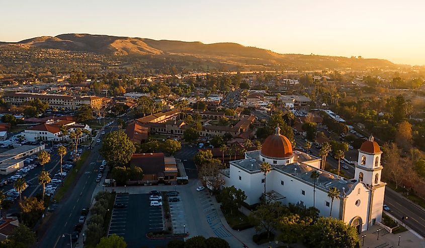 Sunset aerial view of the Spanish Colonial era mission and surrounding city of downtown San Juan Capistrano, California.