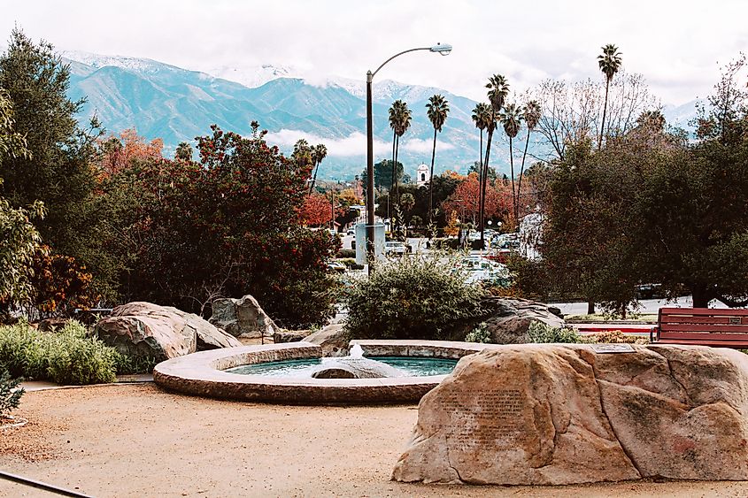 Downtown Ojai, California, with a view of the surrounding mountains covered in winter snow.