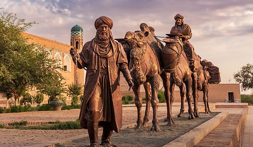 Sculpture of an ancient caravan with camels carrying various goods along the Silk Road in Uzbekistan.
