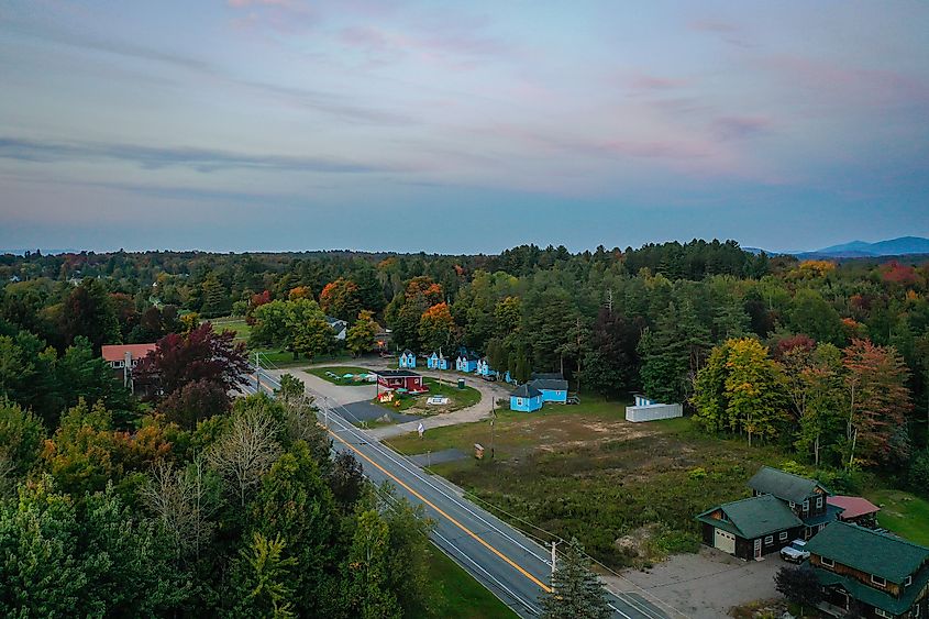 Sunset over Tupper Lake, NY, Adirondacks in early fall aerial.