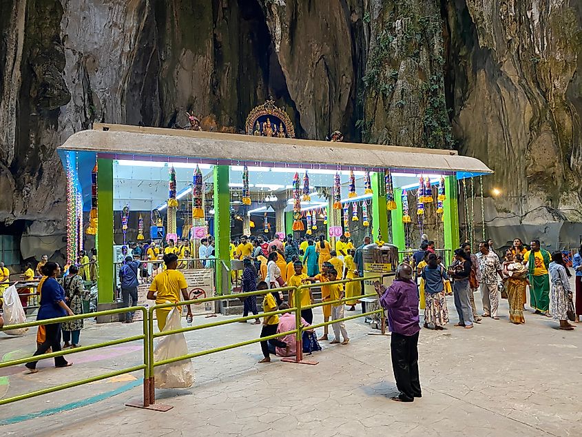 Hindus offering their devotion at a cave temple.