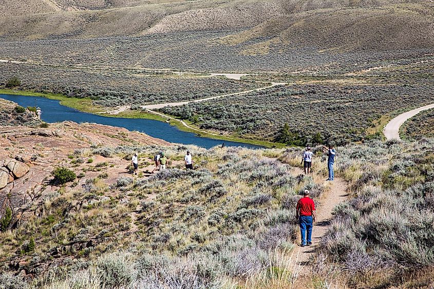 People hiking on a trail along the north platte river just downstream from Pathfinder dam, near Alcova, Wyoming.