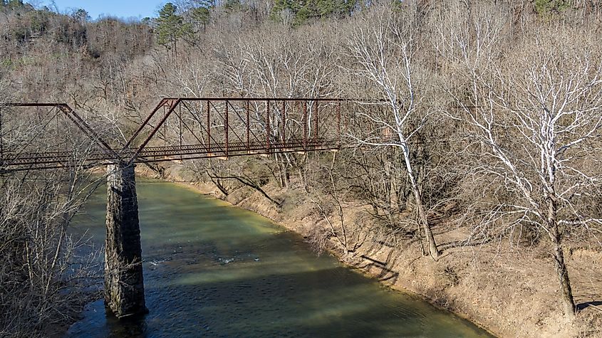 Old abandoned iron bridge over locust fork river in Warrior, Alabama, in winter.