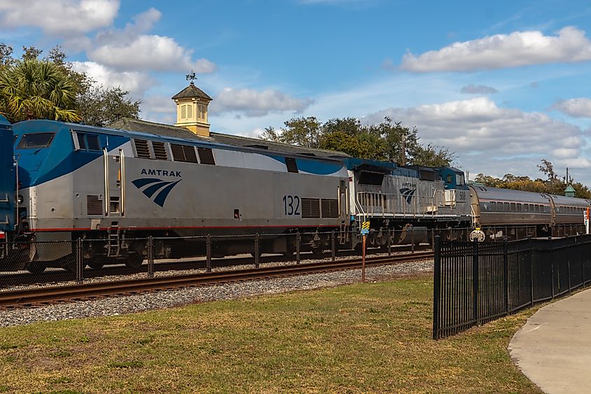 Amtrak train locomotive engine pulling into the train station platform in Kissimmee, Florida